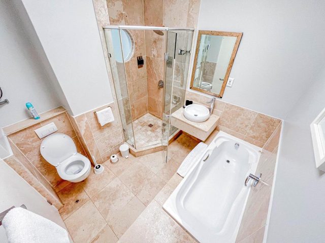 Bathroom with a bath and shower