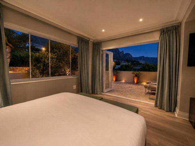 Bedroom at night with a mountain view