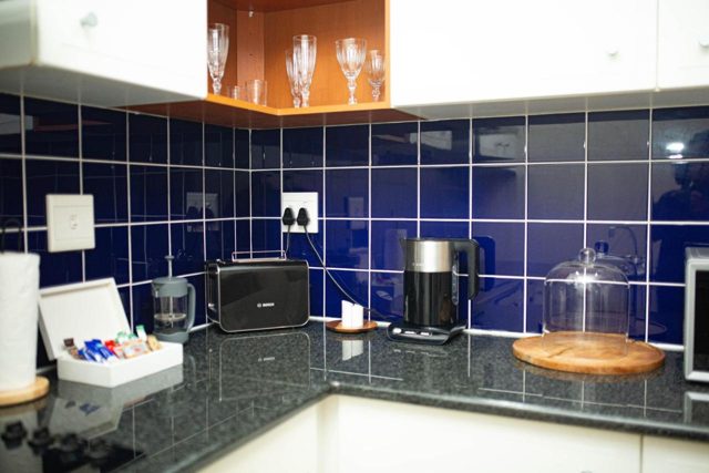 Kitchenette with tiled splashback