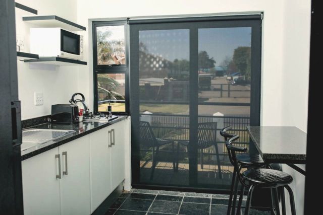 Kitchenette with microwave and bar stools
