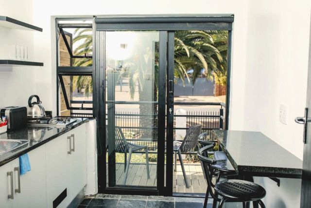 Kitchenette with glass doors opening onto a balcony