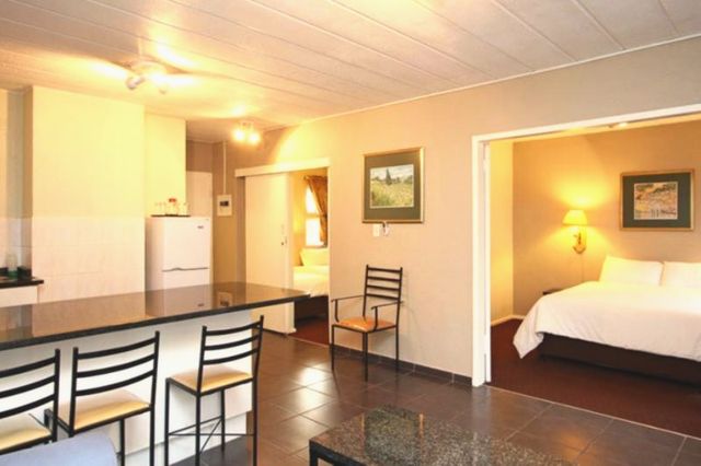 Kitchen with breakfast bar and a bedroom beyond