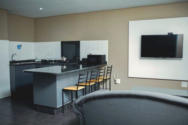Kitchen with breakfast bar and wall-mounted TV